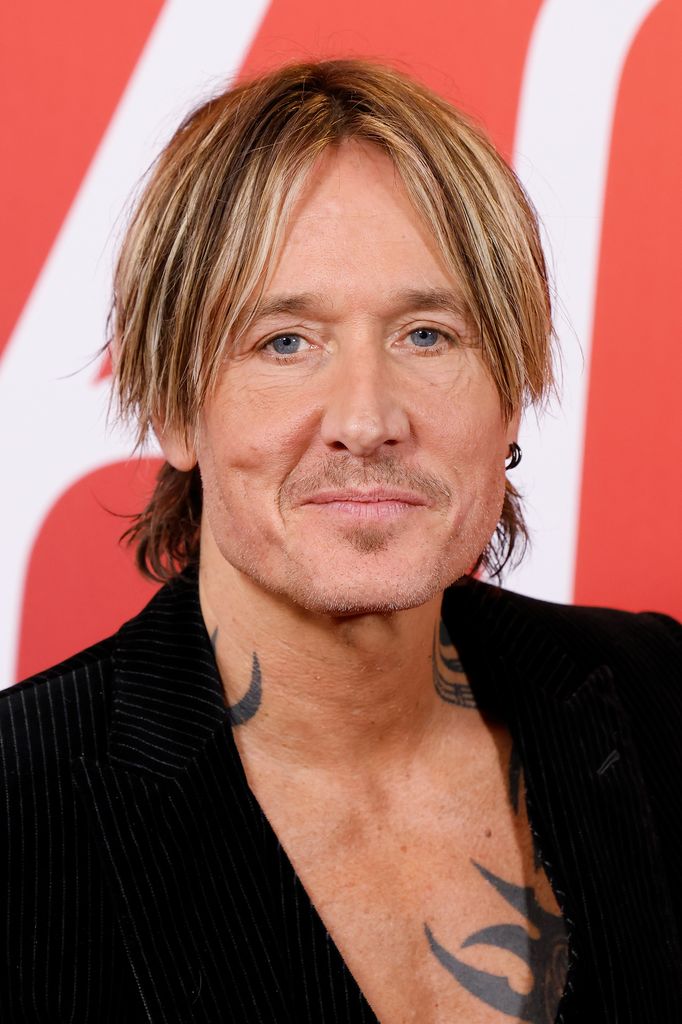photo of keith urban in black jacket no shirt