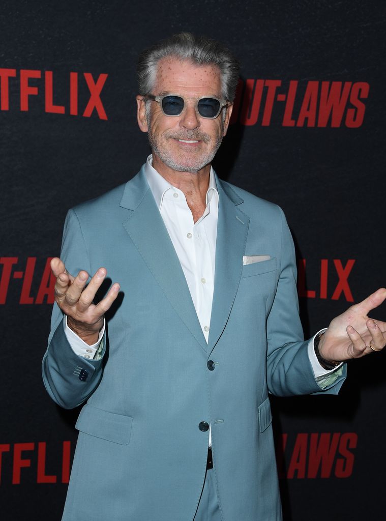 Pierce Brosnan in a blue suit and sunglasses