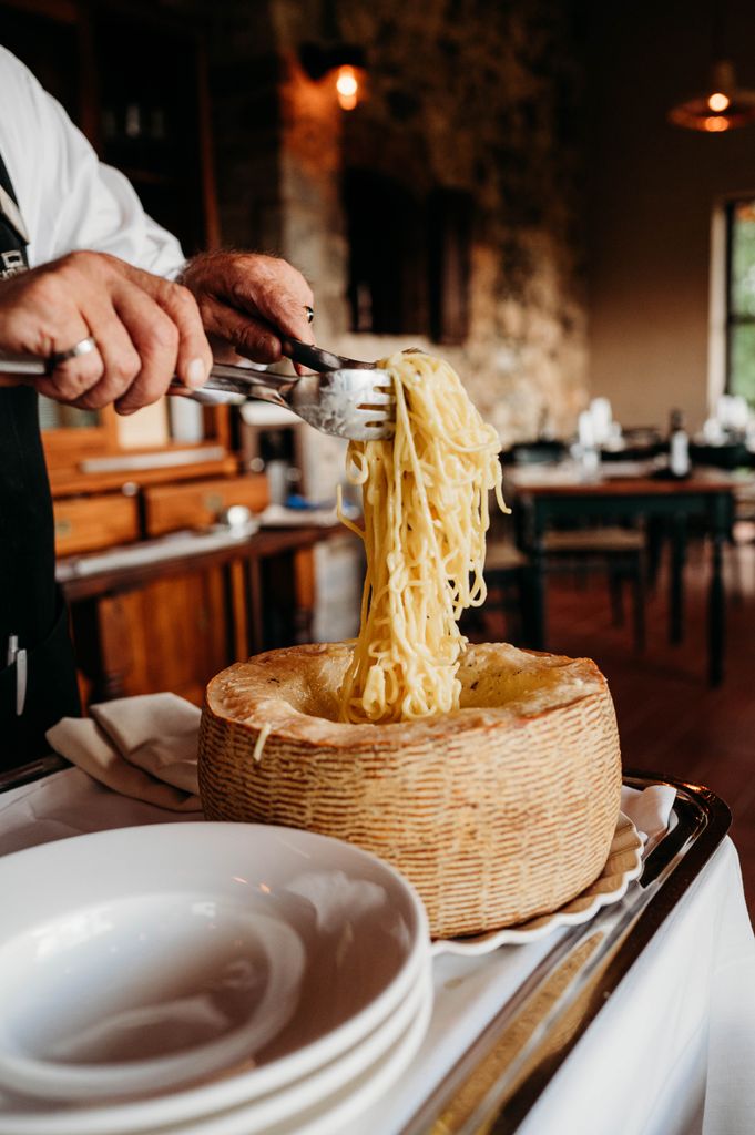 A chef preparing a tagliolini creamed in cheese with truffle