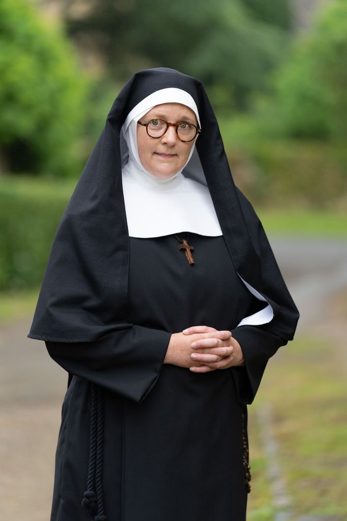 nun standing in garden