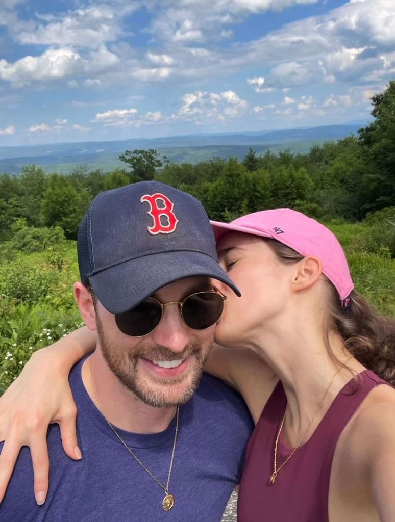 Chris Evans is kissed on the neck by Alba Baptista during a walk