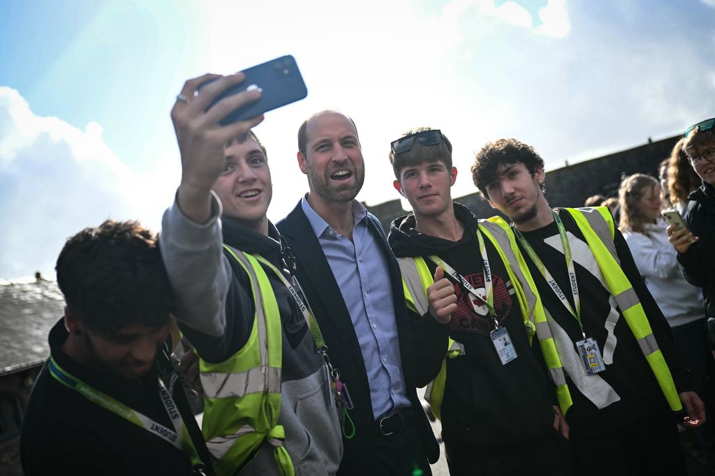 Prince William taking a selfie with a group of students