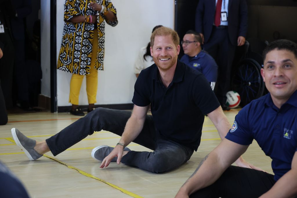 Prince Harry sitting on court floor