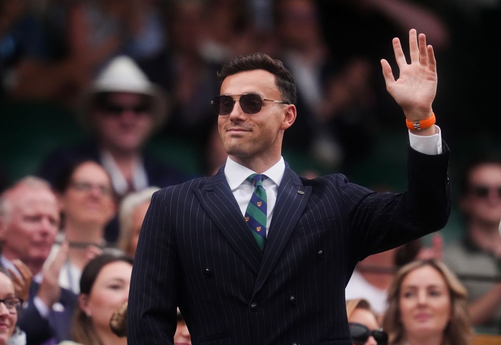 James Guy waving in suit