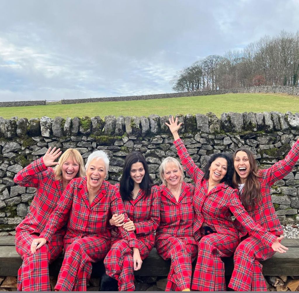 Group of women in check pyjamas outside