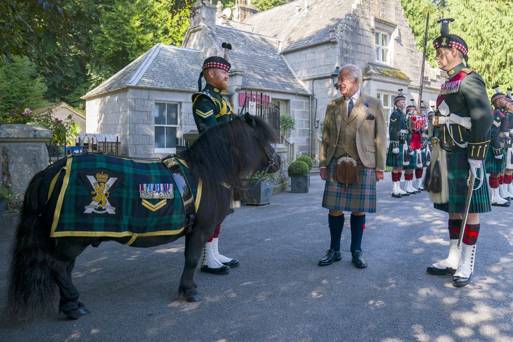 King Charles III meets Shetland pony Cpl Cruachan IV (mascot of the Royal Regiment of Scotland) during an inspection of the Balaklava Company, 5th Battalion, The Royal Regiment of Scotland, at the gates of Balmoral