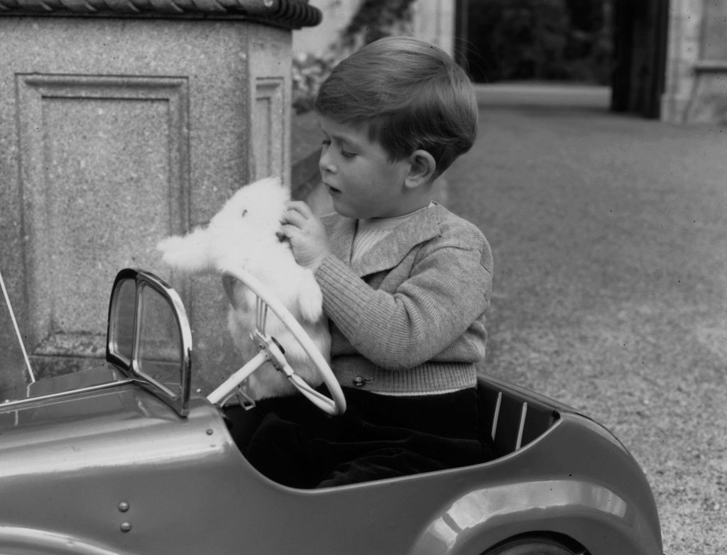 King Charles, eldest son of Queen Elizabeth II and the Duke of Edinburgh, playing with a glove puppet in his toy car whilst staying at Balmoral 