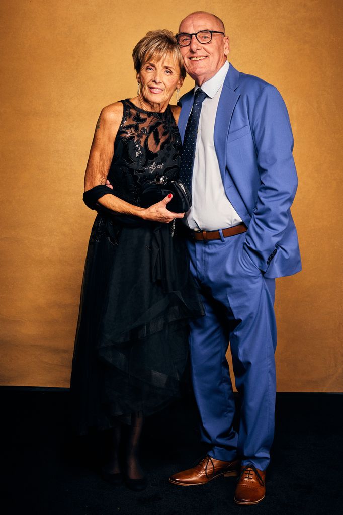 Shirley Griffiths in a black dress with Dave in a blue suit