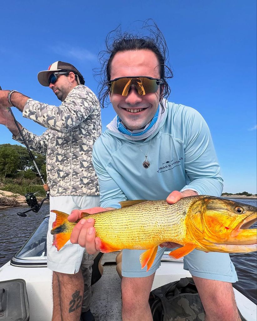 Taylor Seager-Green holding a Golden Dorado fish. 