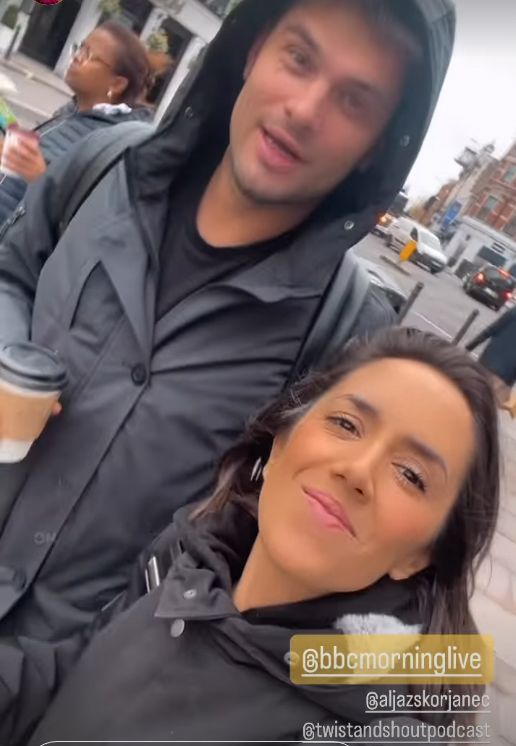 Aljaz Skorjanec and Janette Manrara walking in the rain holding coffee cups