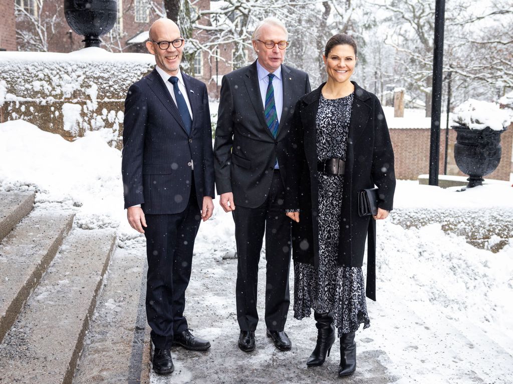 Crown Princess Victoria in leopard print with two men in snow