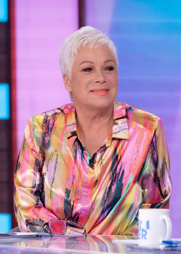 Denise Welch smiling in a colourful shirt on Loose Women