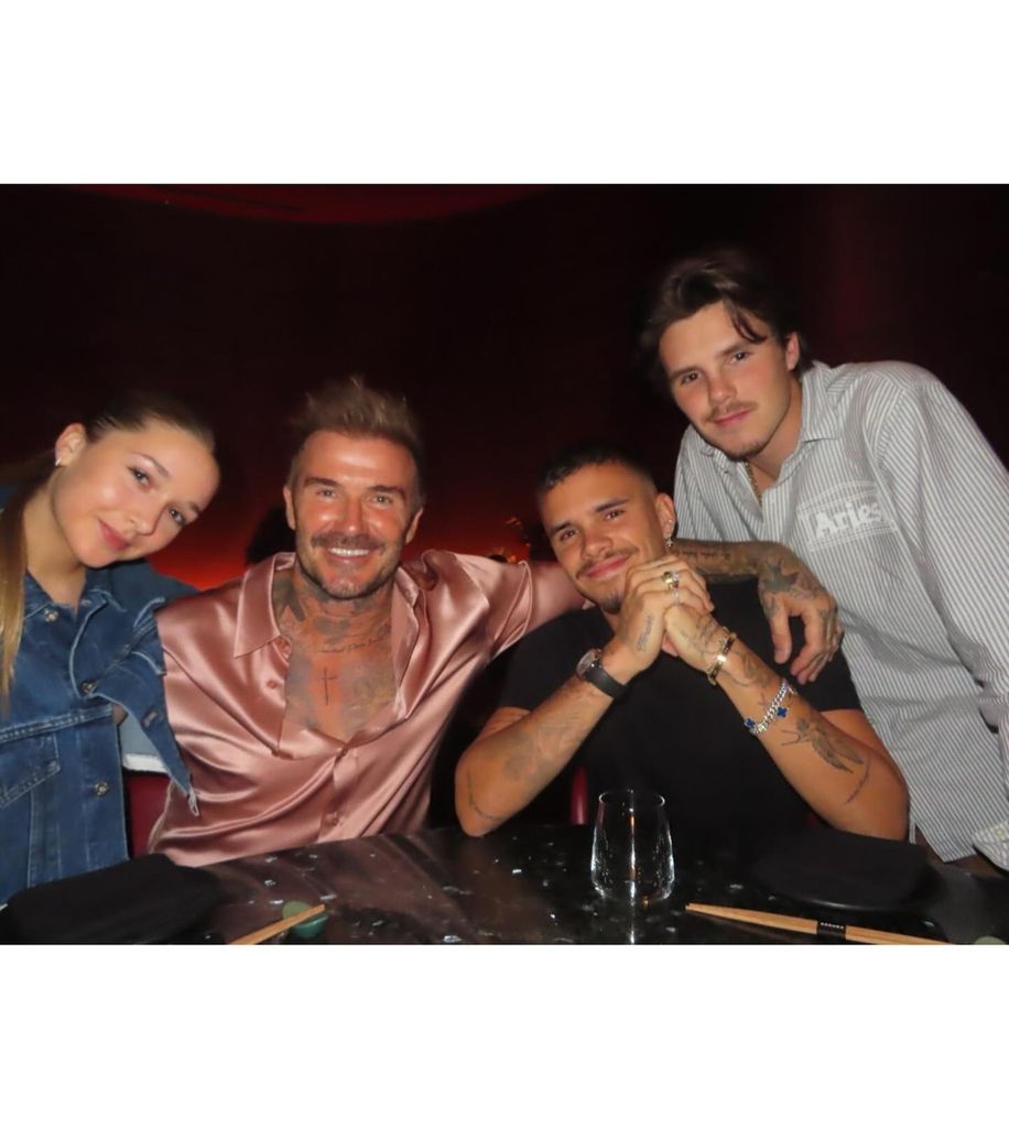 beckham family posing at dinner table