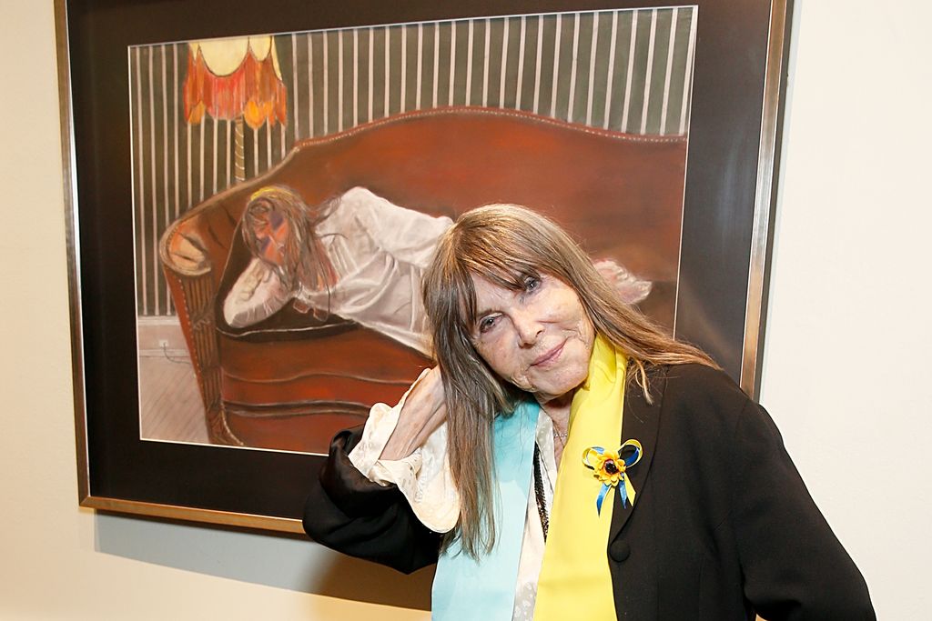 Lee Grant posing by one of the paintings by her husband Joseph Feury 
