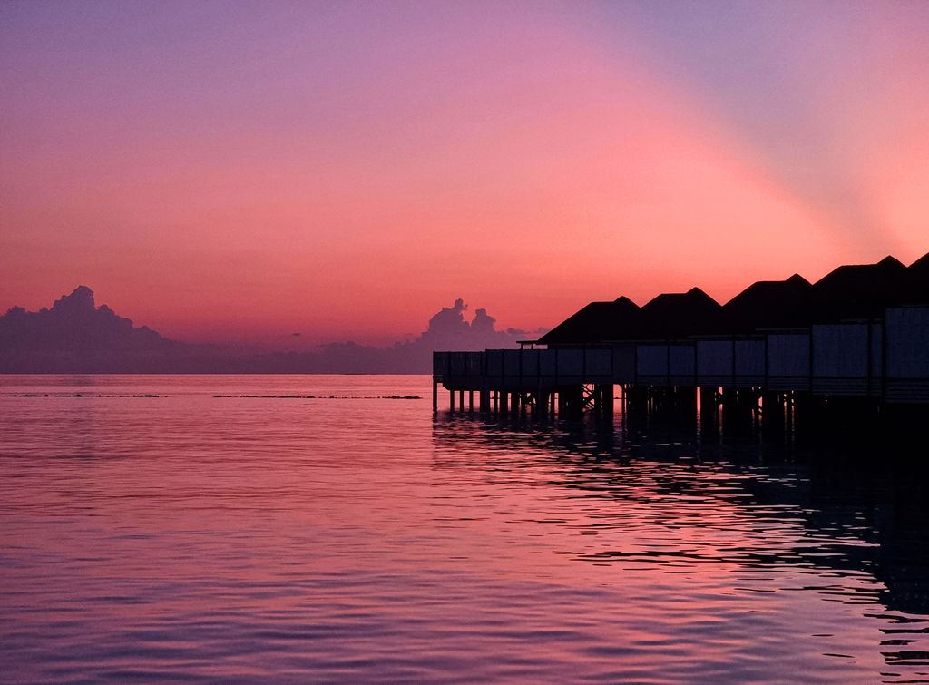 Stunning pink sunset at the water villas at Nova Maldives