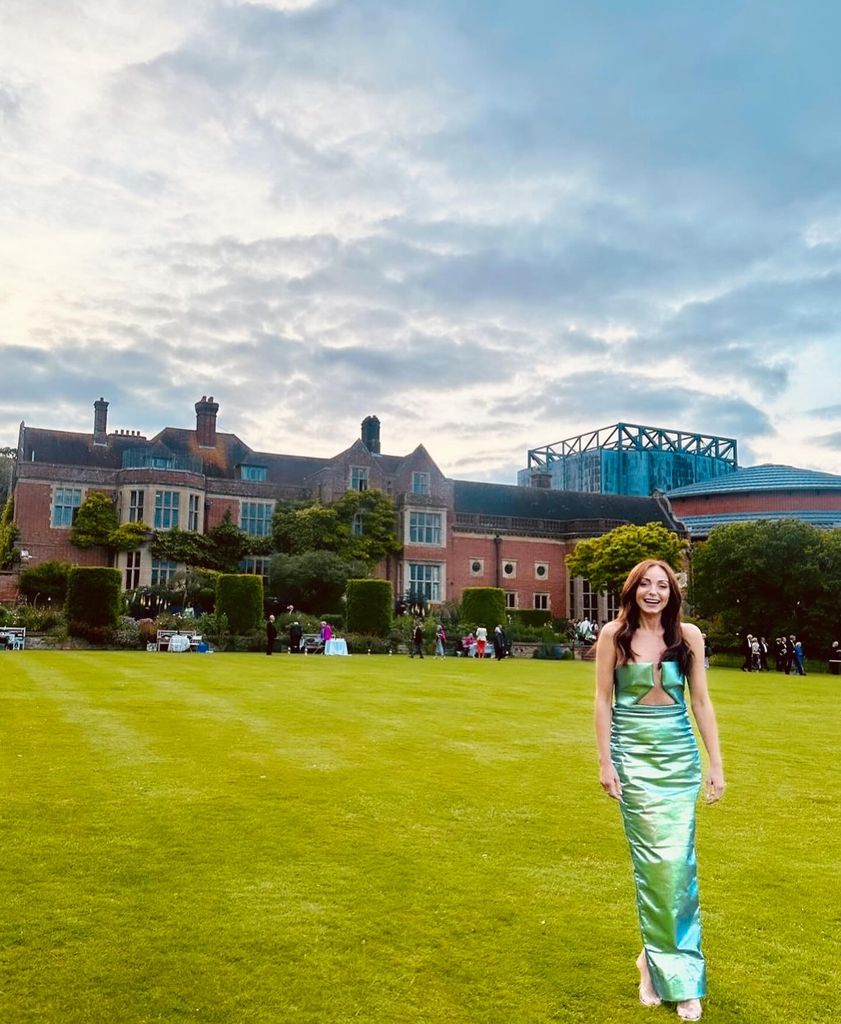 woman in iridescent dress standing on lawn