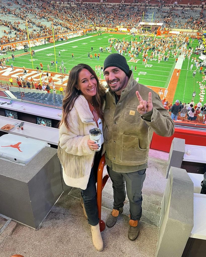 Haylie Duff with husband Matt Rosenberg in the stands at a football stadium 