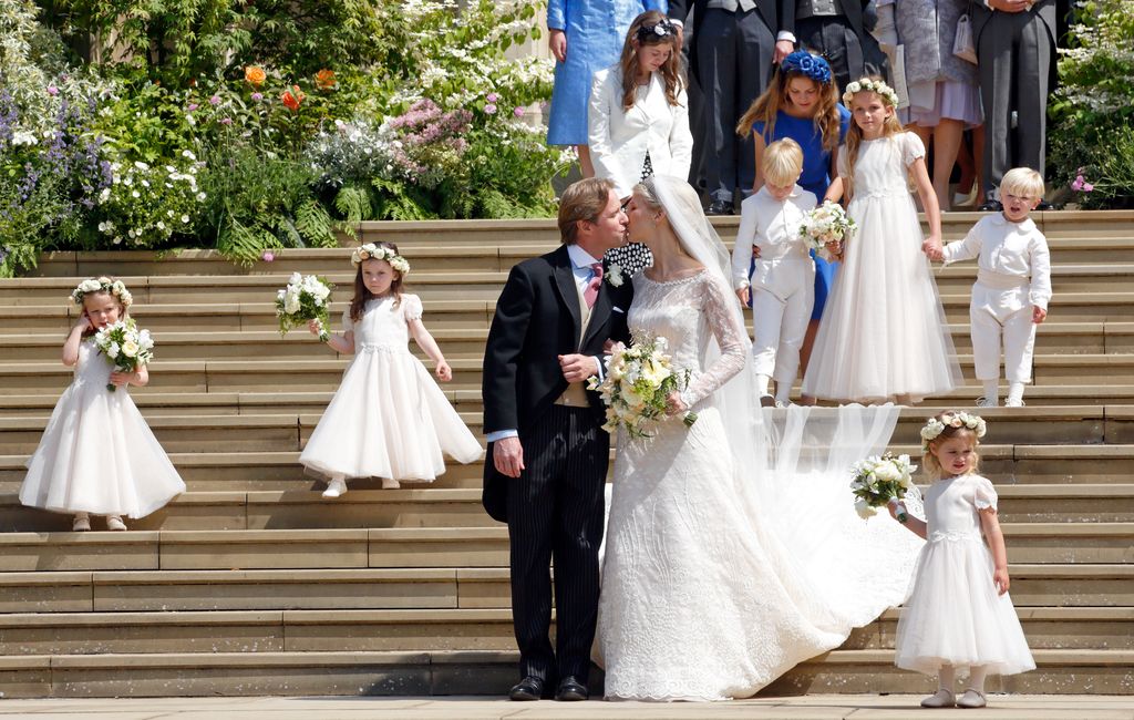 Thomas Kingston and Lady Gabriella Windsor kiss as they leave St George's Chapel after their wedding on May 18, 2019