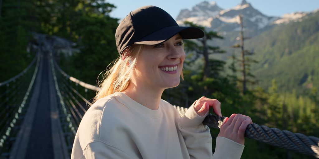 Alexandra Breckenridge as Mel standing on a bridge in the Virgin River