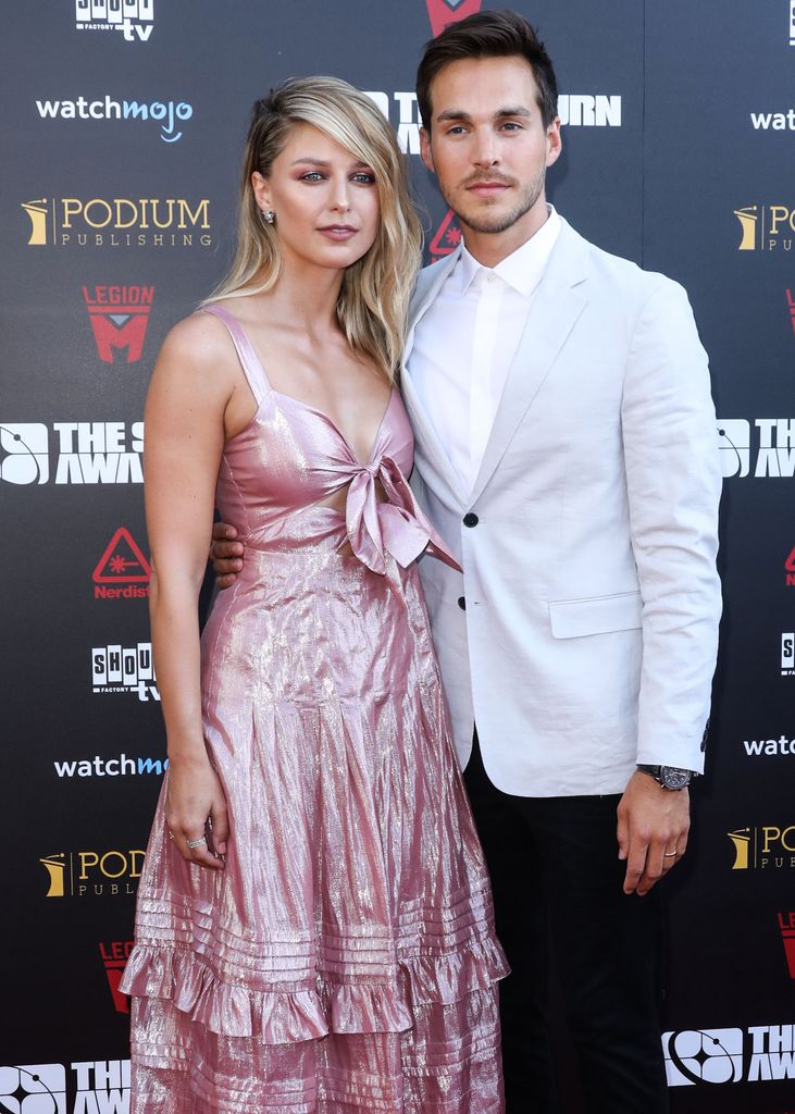 woman and man posing on red carpet