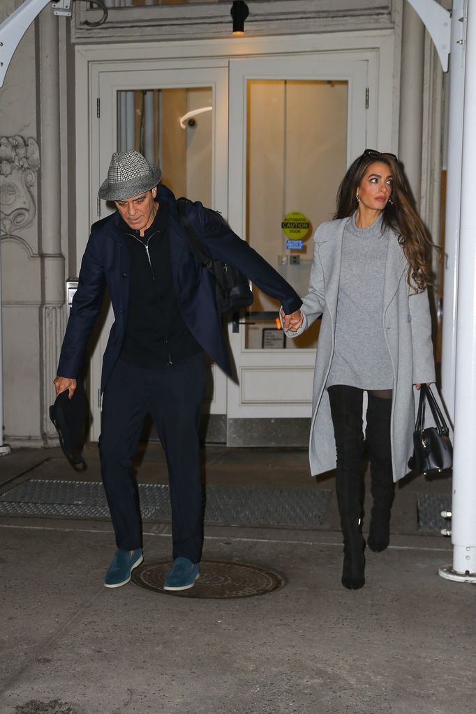 George Clooney and his wife Amal Clooney hold hands as they head out together in New York.