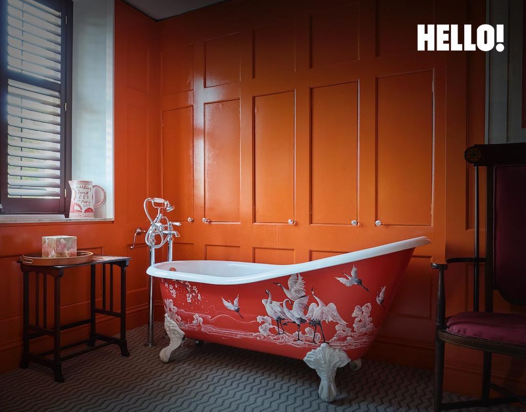 orange bathroom with painted bath