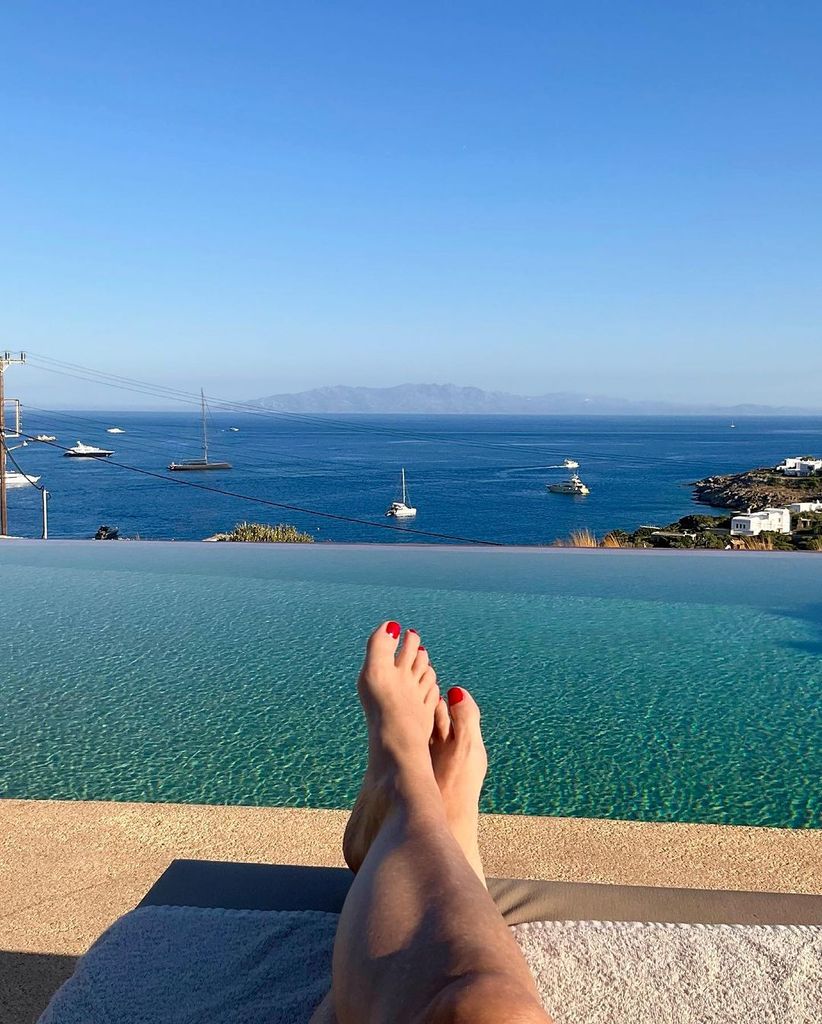 Demi Moore's feet against an infinity pool and the sea