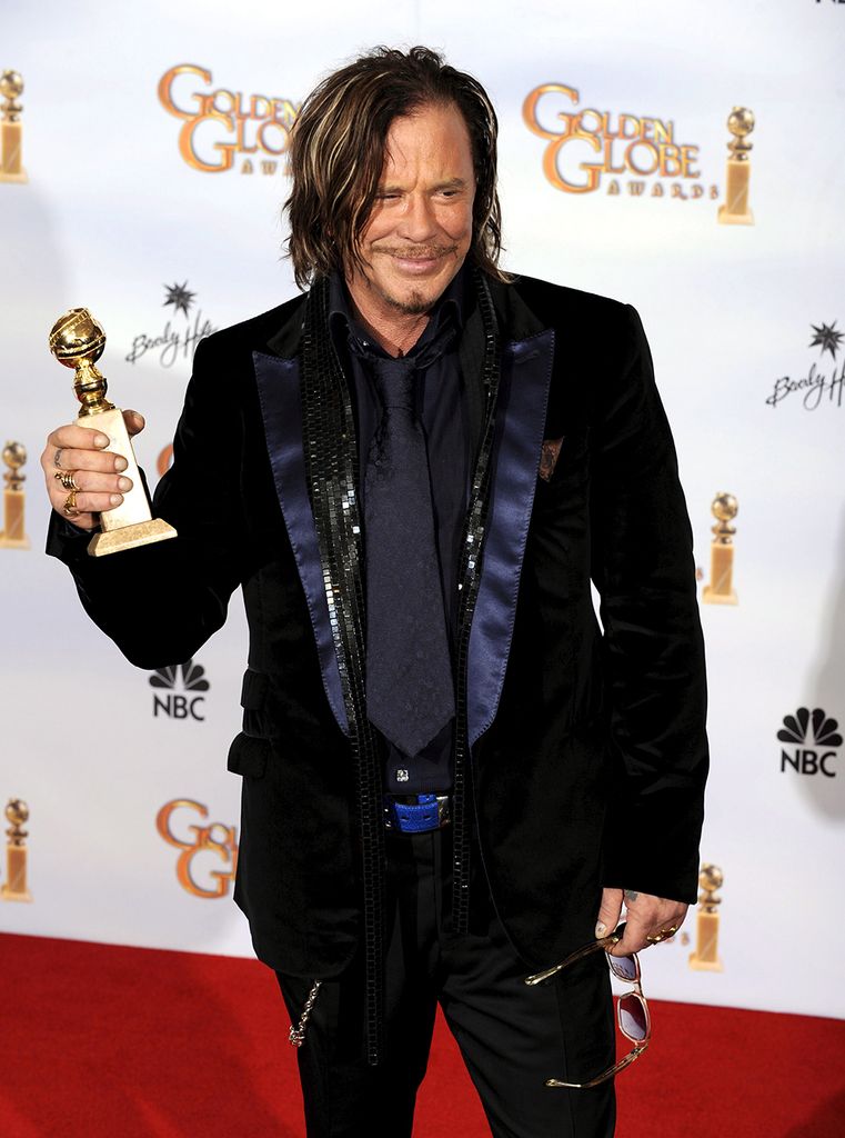Mickey Rourke holding his Golden Globe Award for his performance in The Wrestler (2009)