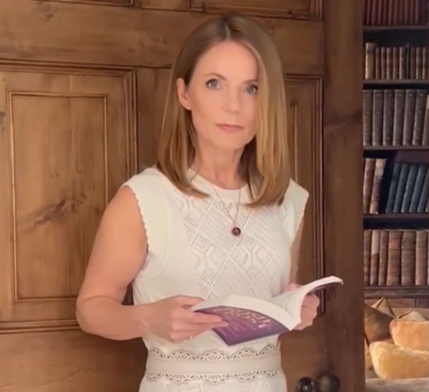 Geri Horner in a library holding a book