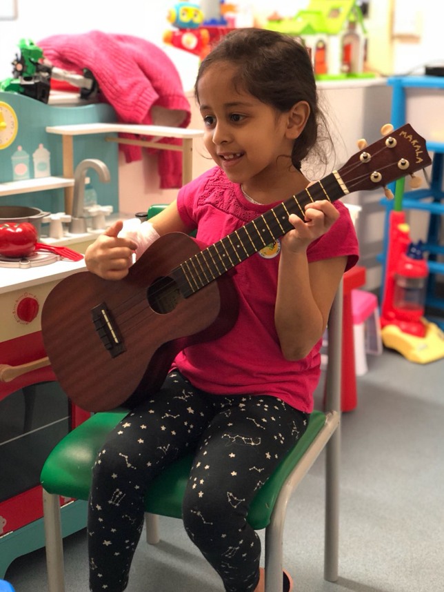 little girl playing guitar