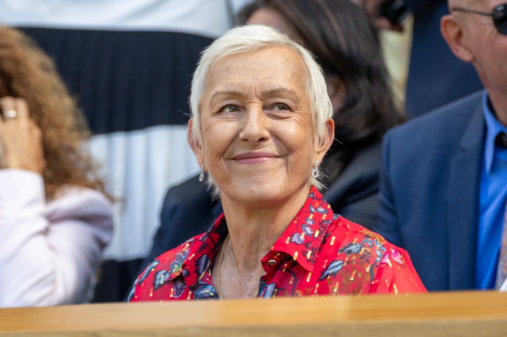 Martina Navratilova in royal box wearing red shirt