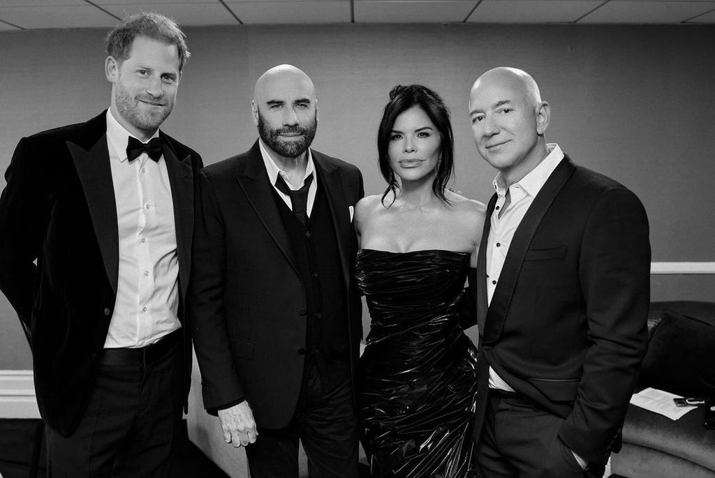 Prince Harry, John Travolta, Lauren Sanchez and Jeff Bezos pose backstage 