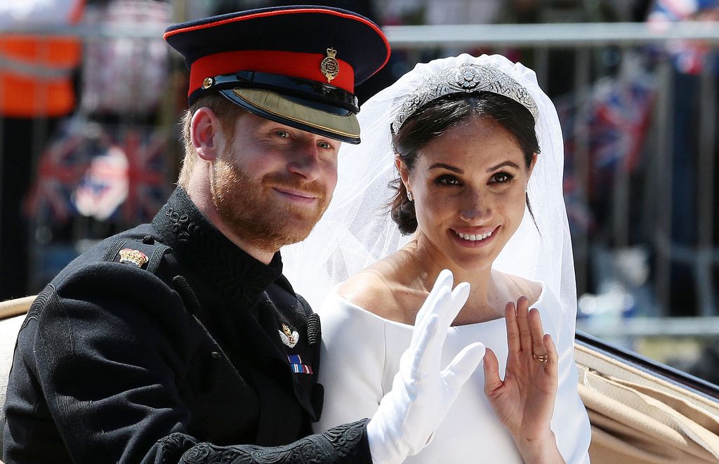 Prince Harry and Meghan waving from carriage on wedding day