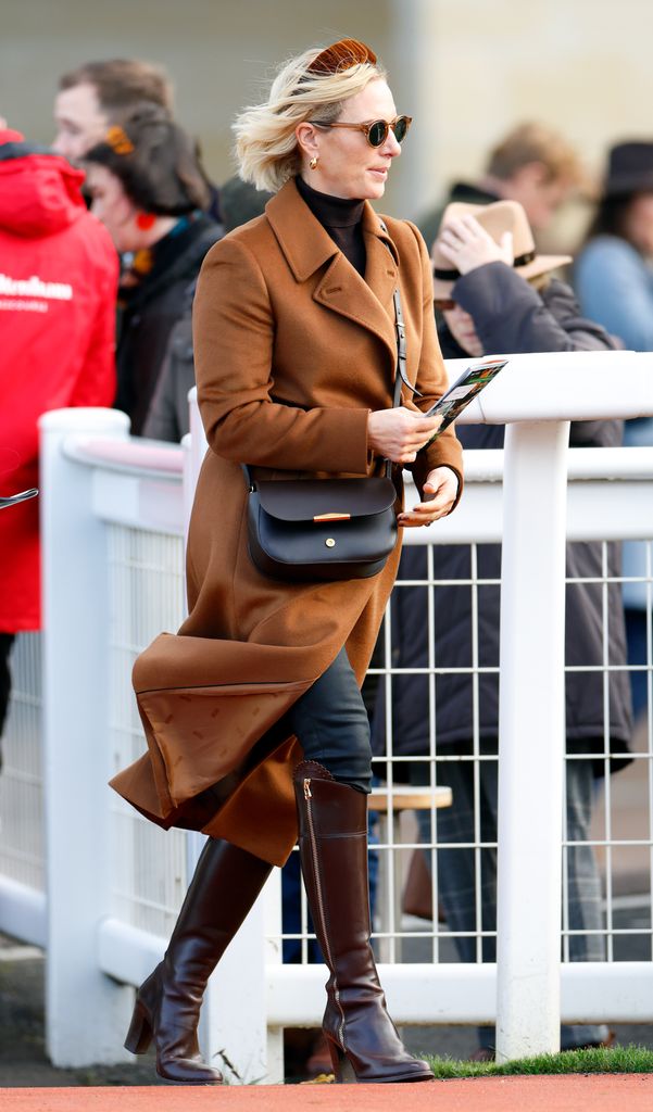 Zara in brown coat and knee-high boots