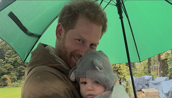 Prince Harry and baby Archie under an umbrella