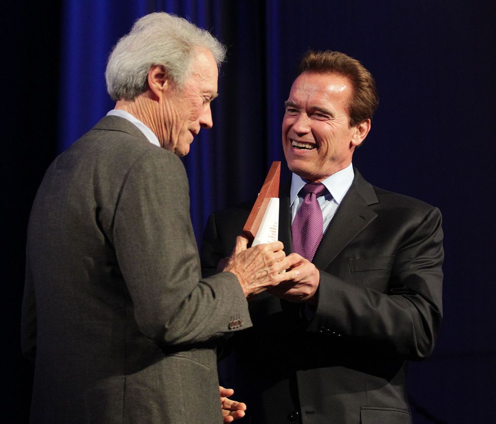Director Clint Eastwood (L) accepts his award from Arnold Schwarzenegger, Governor of California during the Museum of Tolerance International Film Festival Gala on November 14, 2010 in Los Angeles, California