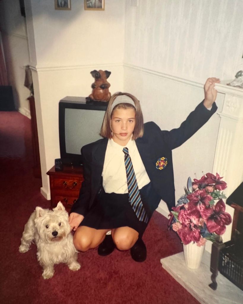 gemma as a teen in school uniform at home with dog