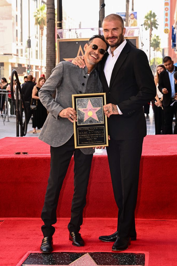 Marc Anthony stands with David Beckham as Anthony receives a star on the Hollywood Walk of Fame during a ceremony in Hollywood, California on September 7, 2023