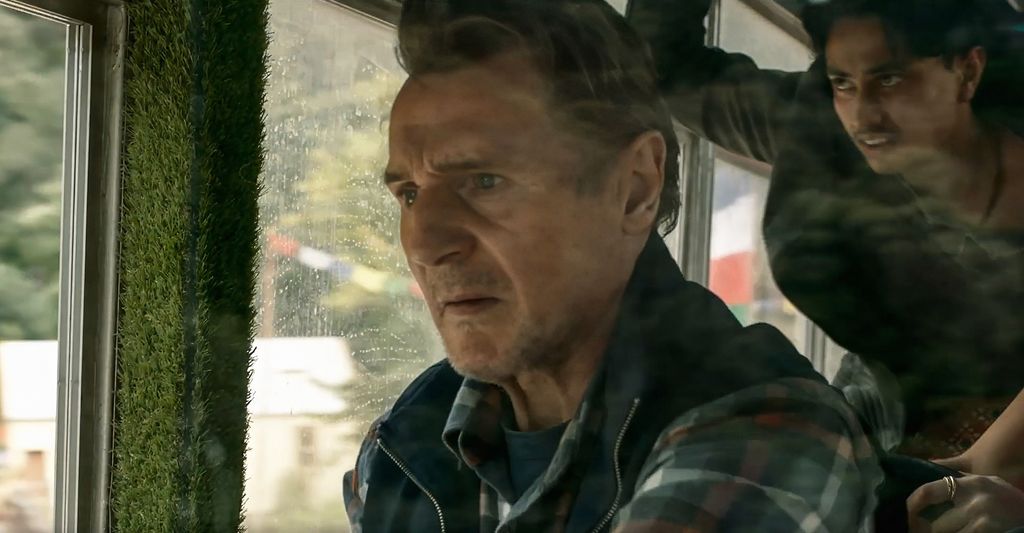Liam Neeson driving a bus in a still from Ice Road: Vengeance