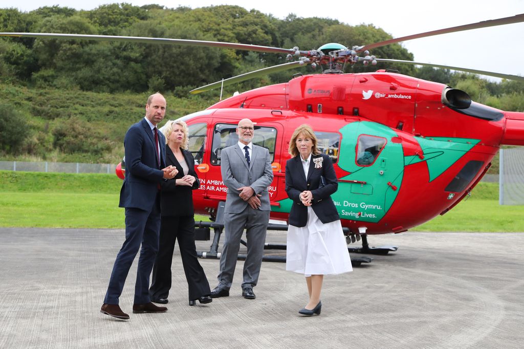 Prince William flanked by  Chief Executive of the Wales Air Ambulance Charity Sue Barnes and Lord Lieutenant of Dyfed Sara Edwards visits the Wales Air Ambulance