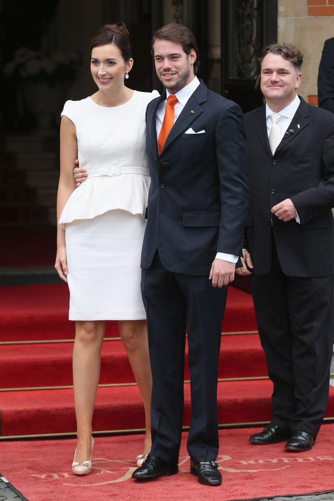 Claire Lademacher in a peplum look on red carpet with husband