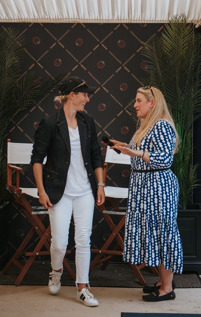 Zara Tindall speaking to a woman in a blue dress