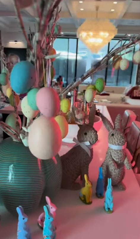 shot of easter egg tree ontop of dining room table surrounded by tall bunnies, in a video taken and posted by Gwen Stefani