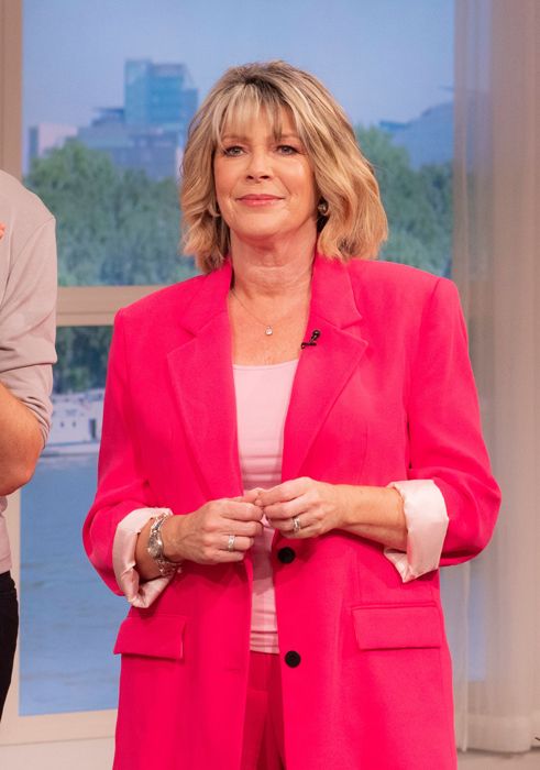 Ruth Langsford presenting This Morning in a bright pink suit