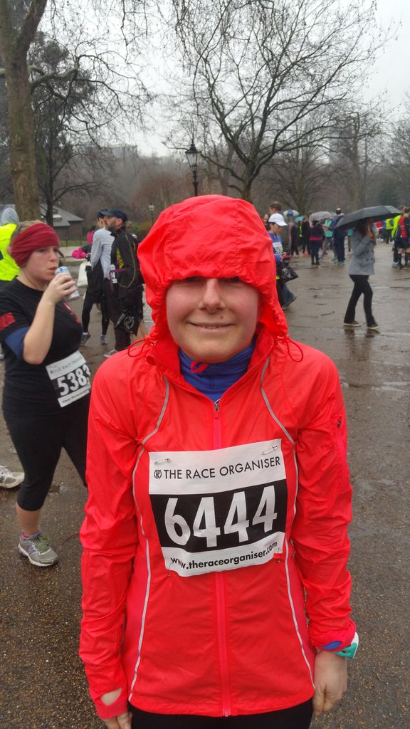 Woman in rain coat ready to run in a race