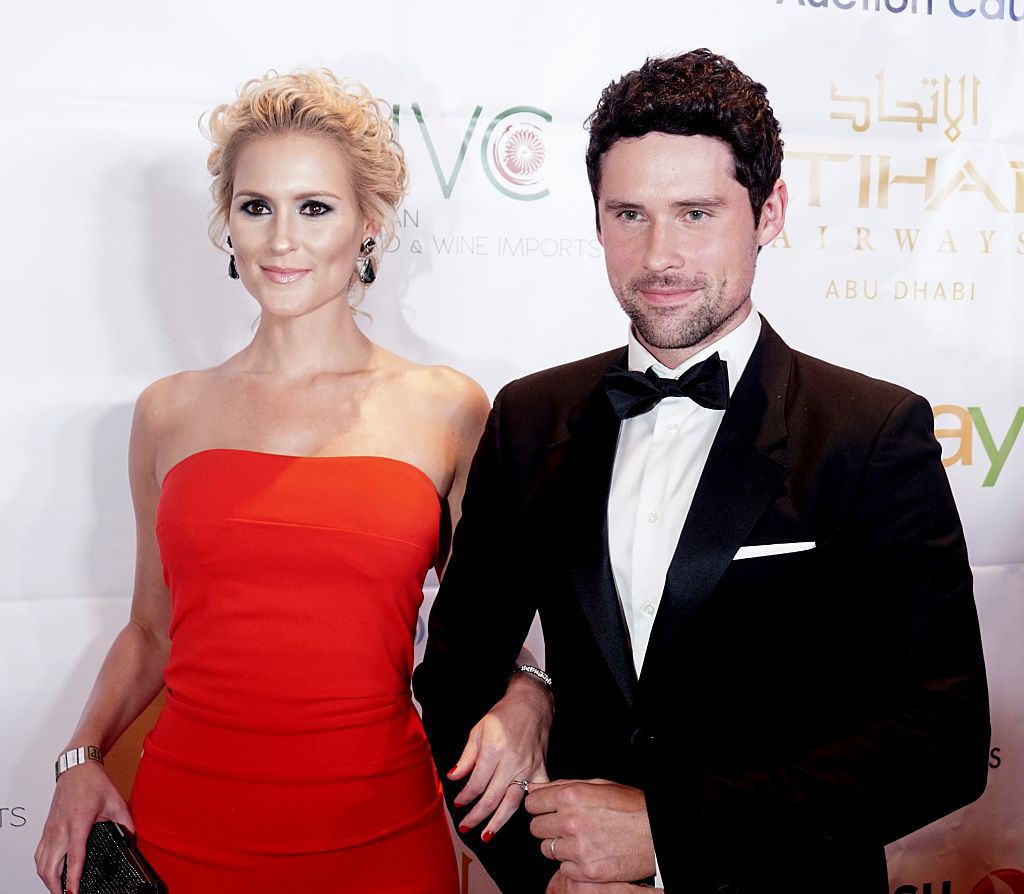 Ben Hollingsworth in a tux and Nila Myers wearing a red strapless gown