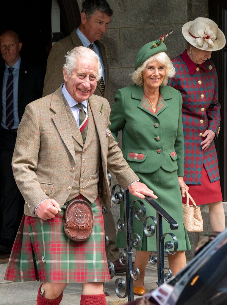 The King and Queen smiling as they leave church in Balmoral