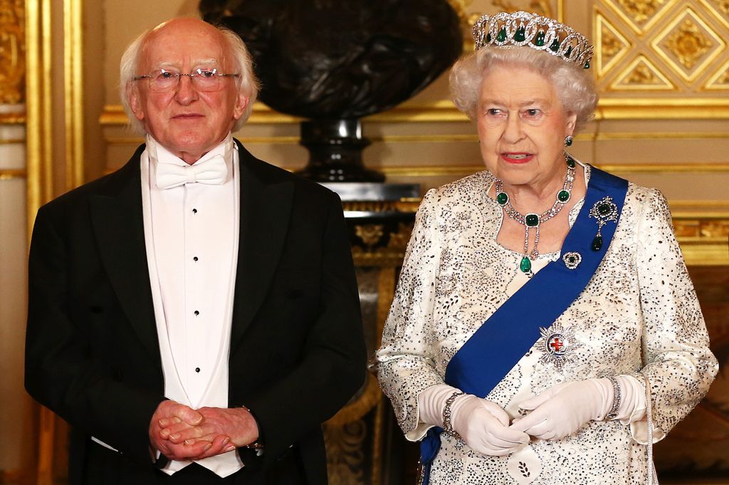 Queen Elizabeth II in a white sparkly dress and brooch for a state banquet in 2014
