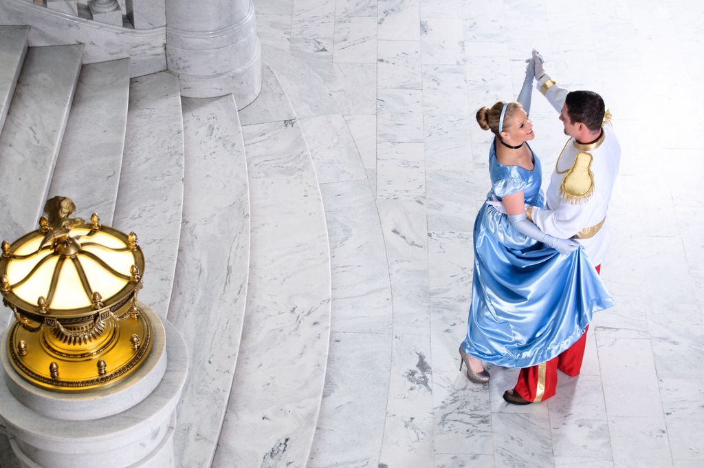 Cinderella and Prince Charming dancing at ball.