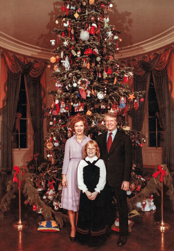 US First Family as they pose in front of the Christmas tree located in the Blue Room of the White House, Washington DC, December 20, 1977. Pictured are (rear) US First Lady Rosalynn Carter and President Jimmy Carter, with their daughter, Amy Carter